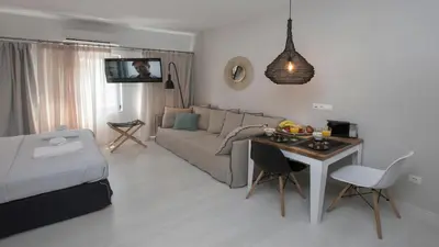 a living room with a couch and a table at Ermou Stylish Suites by GHH in Athens