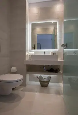 a bathroom with a sink and a toilet and a mirror at Ermou Stylish Suites by GHH in Athens
