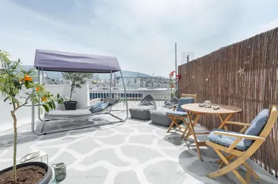 a patio with a table and chairs on a balcony at Island in the sky! Acropolis and city views! in Athens