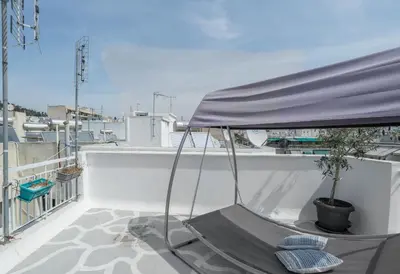 a porch with a hammock on a roof at Island in the sky! Acropolis and city views! in Athens
