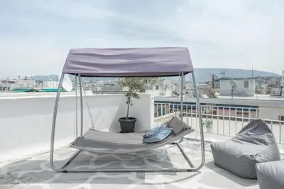 a swing chair sitting on top of a roof at Island in the sky! Acropolis and city views! in Athens