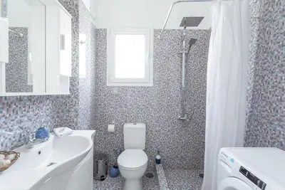 a bathroom with a toilet and a sink and a shower at Island in the sky! Acropolis and city views! in Athens