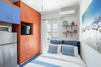 a small room with a bed and a refrigerator at Island in the sky! Acropolis and city views! in Athens