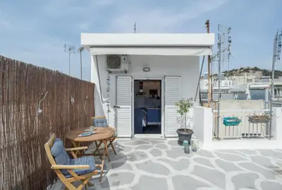 a patio with a table and chairs on a balcony at Island in the sky! Acropolis and city views! in Athens