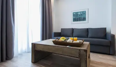 a living room with a couch and a table with a basket of fruit at Spot Apart in Athens