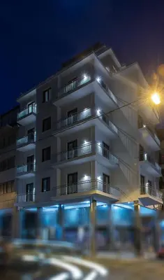 a white building with a street light in front of it at Spot Apart in Athens