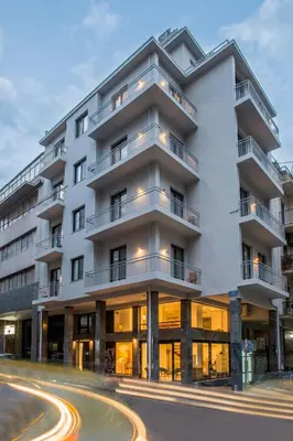 a white building with a street in front of it at Spot Apart in Athens