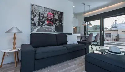 a living room with a blue couch and a table at Spot Apart in Athens