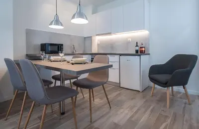 a kitchen with a table and chairs in a room at Spot Apart in Athens