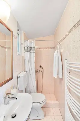 a bathroom with a toilet and a sink at Kate's Beach Villa in Porto Rafti