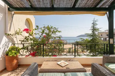 a balcony with a view of the ocean at Kate's Beach Villa in Porto Rafti