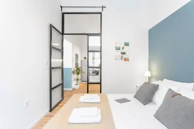 a white living room with a white couch and a mirror at Downtown Boutique Apartments Acropolis View in Athens