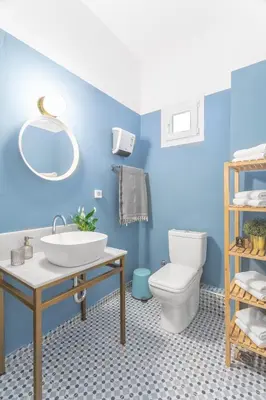 a blue bathroom with a sink and a toilet at Downtown Boutique Apartments Acropolis View in Athens