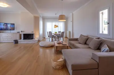 a living room with a couch and a table at Rhea - Glyfada Sea View apartment in Athens