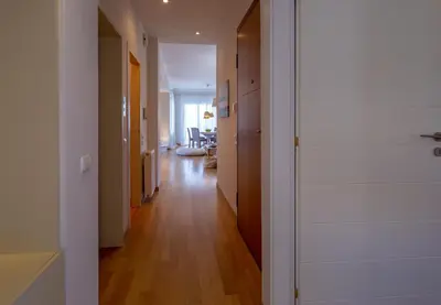 a hallway leading to a living room with wood floors at Rhea - Glyfada Sea View apartment in Athens