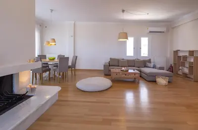 a living room with a couch and a table at Rhea - Glyfada Sea View apartment in Athens