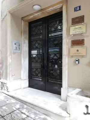 a black door on the side of a building at Classy & Charming 1BD Apartment in Kolonaki by UPSTREET in Athens