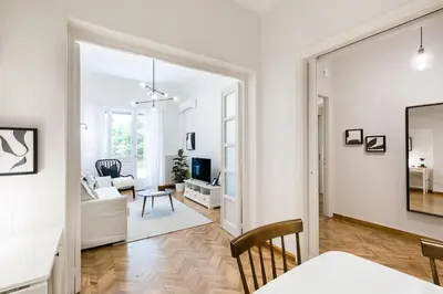 a white living room with a couch and a table at Classy & Charming 1BD Apartment in Kolonaki by UPSTREET in Athens