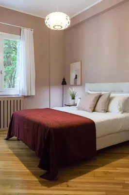 a bedroom with a large bed with a red blanket at Classy & Charming 1BD Apartment in Kolonaki by UPSTREET in Athens