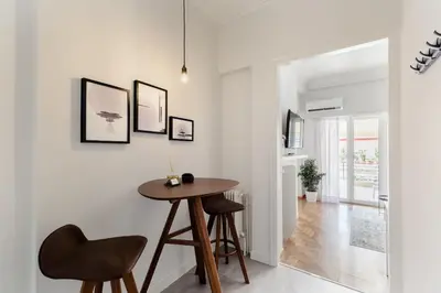 a dining room with a table and two chairs at Classy Luminous 1BD Apartment in Kolonaki by UPSTREET in Athens
