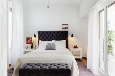 a bedroom with a large bed with a black headboard at Classy Luminous 1BD Apartment in Kolonaki by UPSTREET in Athens