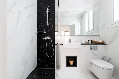 a bathroom with a shower and a toilet and a sink at Classy Luminous 1BD Apartment in Kolonaki by UPSTREET in Athens