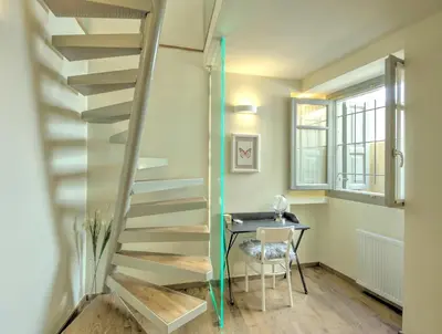 a staircase in a room with a table and a window at Stylish and cozy house in Athens, Plaka in Athens