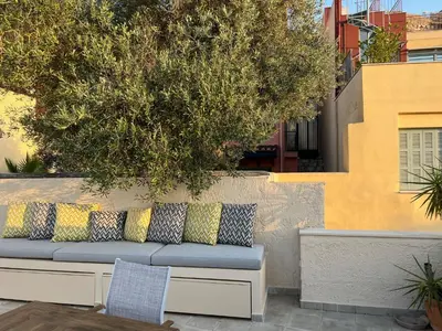a bench with pillows on top of a wall at Stylish and cozy house in Athens, Plaka in Athens