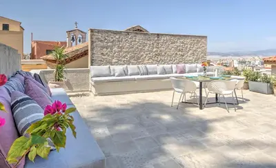 a patio with a couch and a table and chairs at Stylish and cozy house in Athens, Plaka in Athens