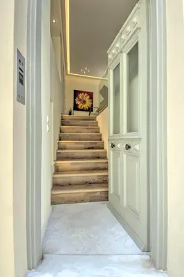 a hallway with a door leading to a stairway at Stylish and cozy house in Athens, Plaka in Athens