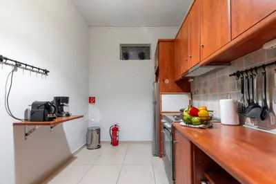 a kitchen with a counter with a bowl of fruit on it at Athens Near Acropolis in Athens