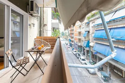 an apartment balcony with a view of a street at Athens Near Acropolis in Athens