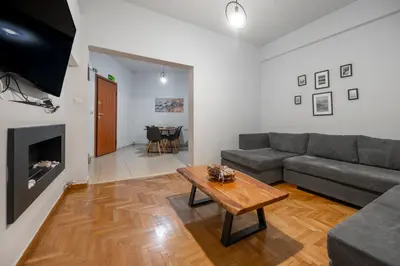 a living room with a couch and a table at Athens Near Acropolis in Athens