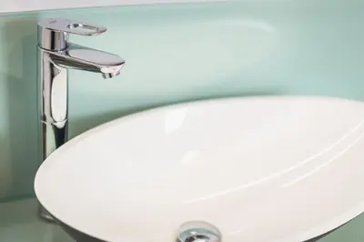 a white bathroom sink with a chrome faucet at Athens Tower Boutique Apartment in Athens