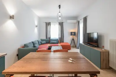 a living room with a table and a couch at Athens Tower Boutique Apartment in Athens