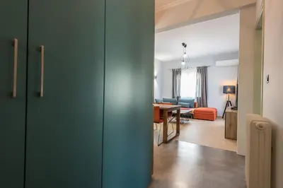 a room with a door and a living room at Athens Tower Boutique Apartment in Athens