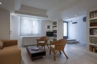 a living room with a couch and chairs and a table at Right under the Acropolis in Athens