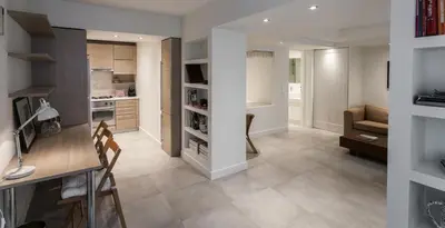 a kitchen and living room with a table and a couch at Right under the Acropolis in Athens