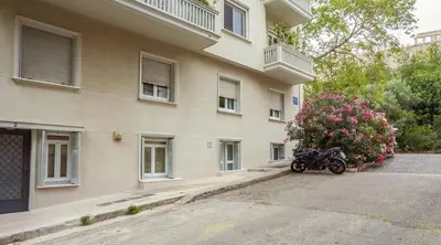 a motorcycle parked in front of a building at Right under the Acropolis in Athens