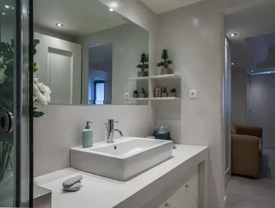 a white bathroom with a sink and a mirror at Right under the Acropolis in Athens