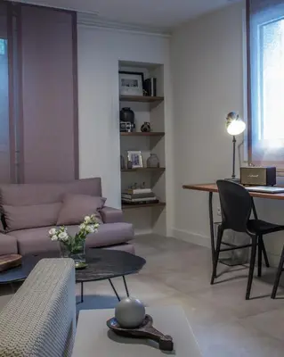 a living room with a couch and a table at Unique Semi-Basement Stay at the Foot of the Acropolis in Athens
