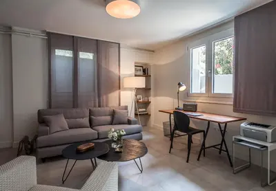 a living room with a couch and a table at Unique Semi-Basement Stay at the Foot of the Acropolis in Athens