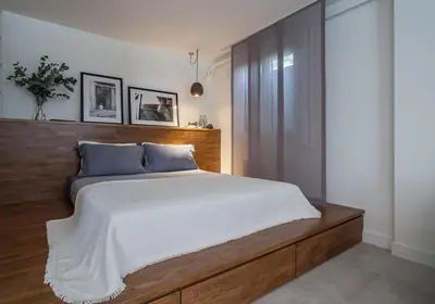 a bedroom with a large bed with a wooden headboard at Unique Semi-Basement Stay at the Foot of the Acropolis in Athens