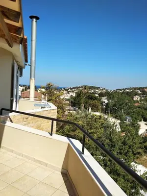 a balcony of a house with a view of a city at Artemis GreenHill in Vravrona