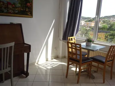a dining room with a table and chairs and a window at Artemis GreenHill in Vravrona