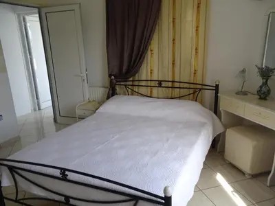 a bedroom with a bed and a dresser at Artemis GreenHill in Vravrona
