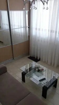 a living room with a glass table and a couch at Keratea Apartment Athens Airport in Keratea