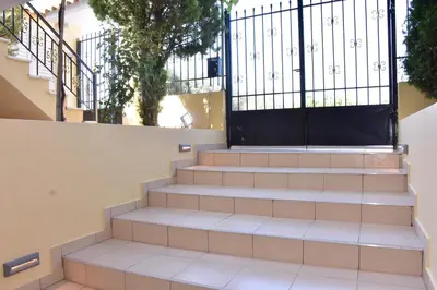 a set of stairs with a black gate at Keratea Apartment Athens Airport in Keratea