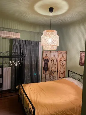 a bedroom with a bed and a chandelier at Cosy and comfort flat, heart of Athens in Athens
