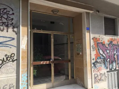 an entrance to a building with a glass door at Cosy and comfort flat, heart of Athens in Athens